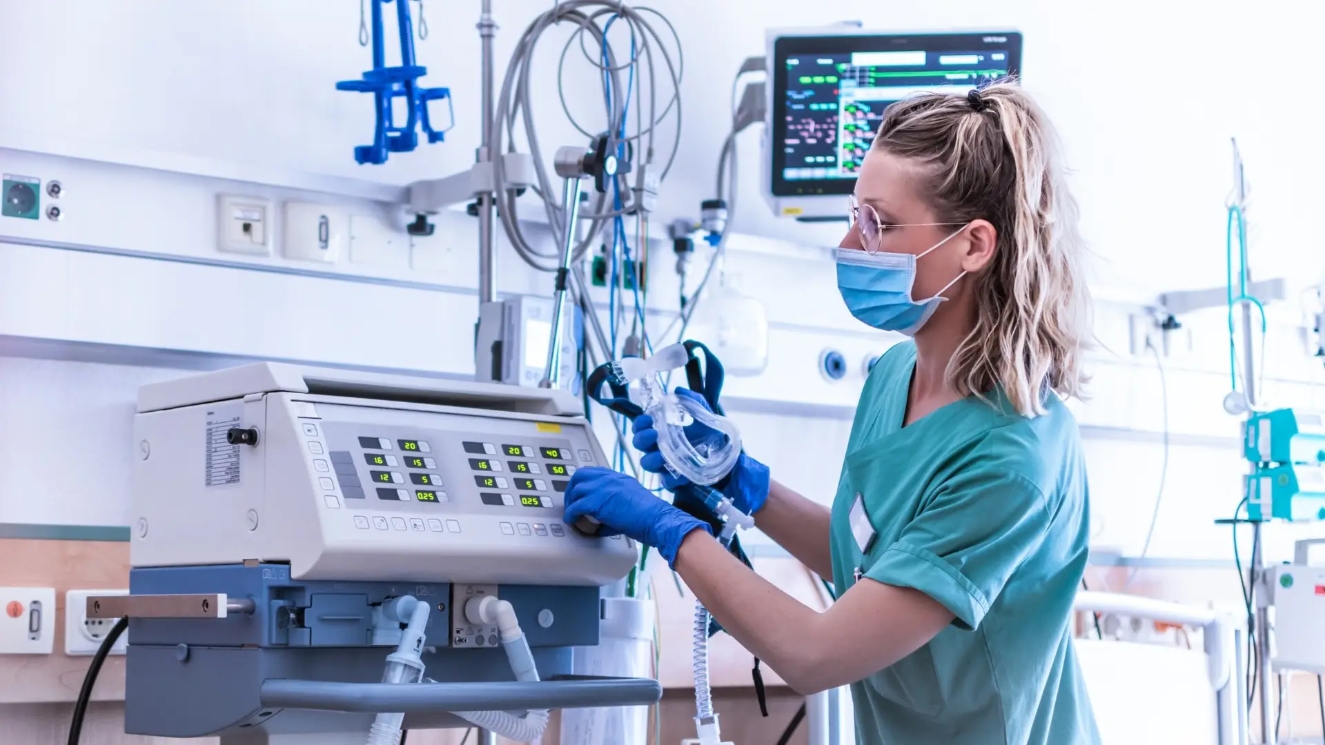 Nurse working on medical equipment at a hospital.